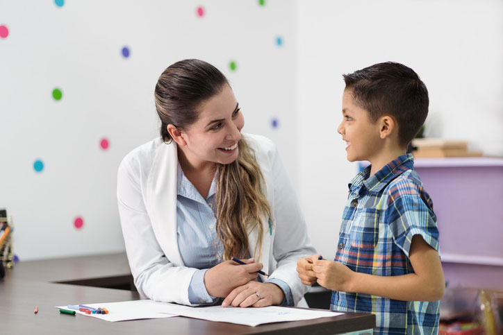 young boy playing with psychologist