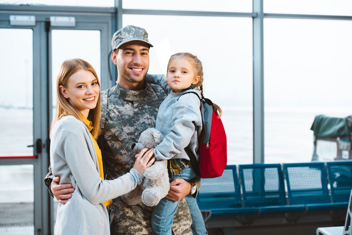 military husband and father with his family