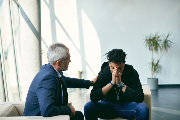 depressed teen talking with counseling psychologist